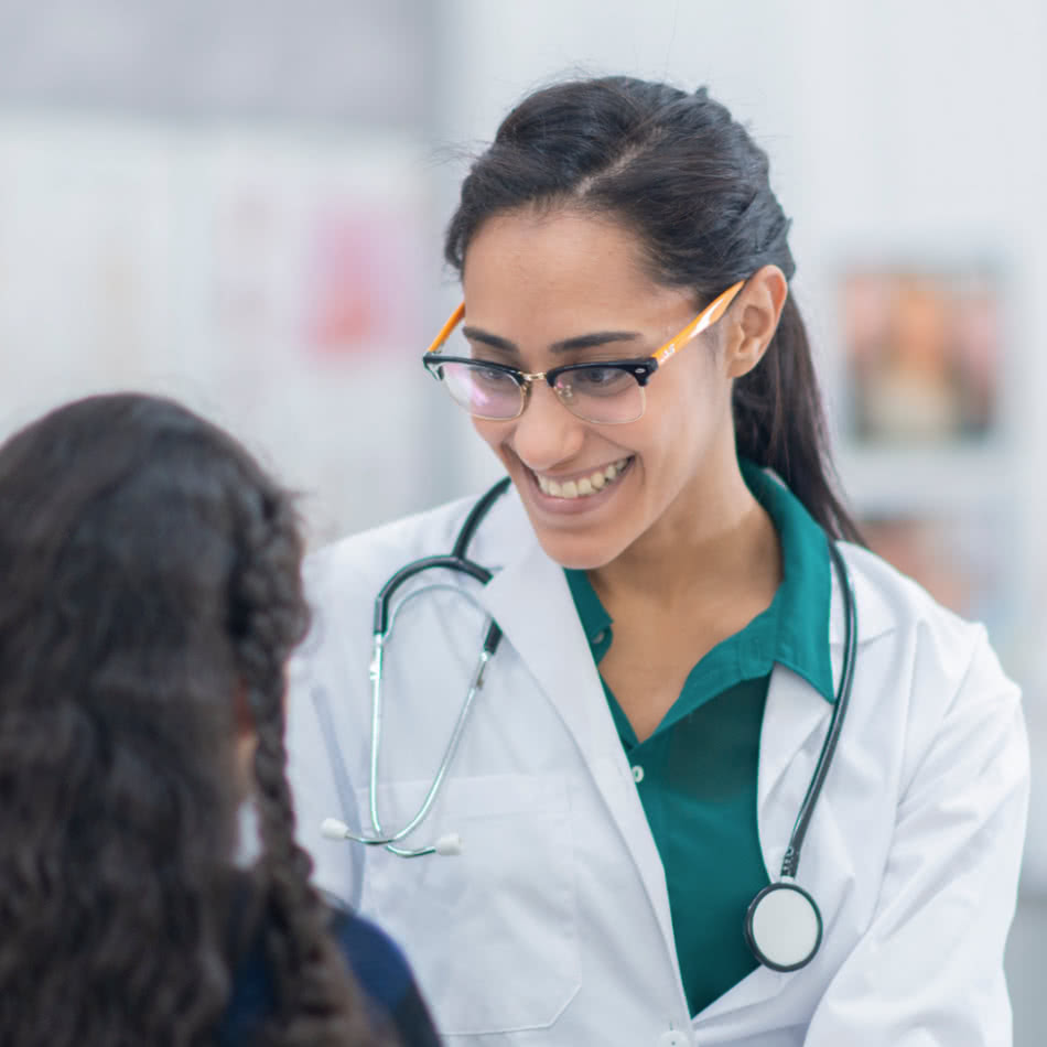 Care provider smiling at young patient