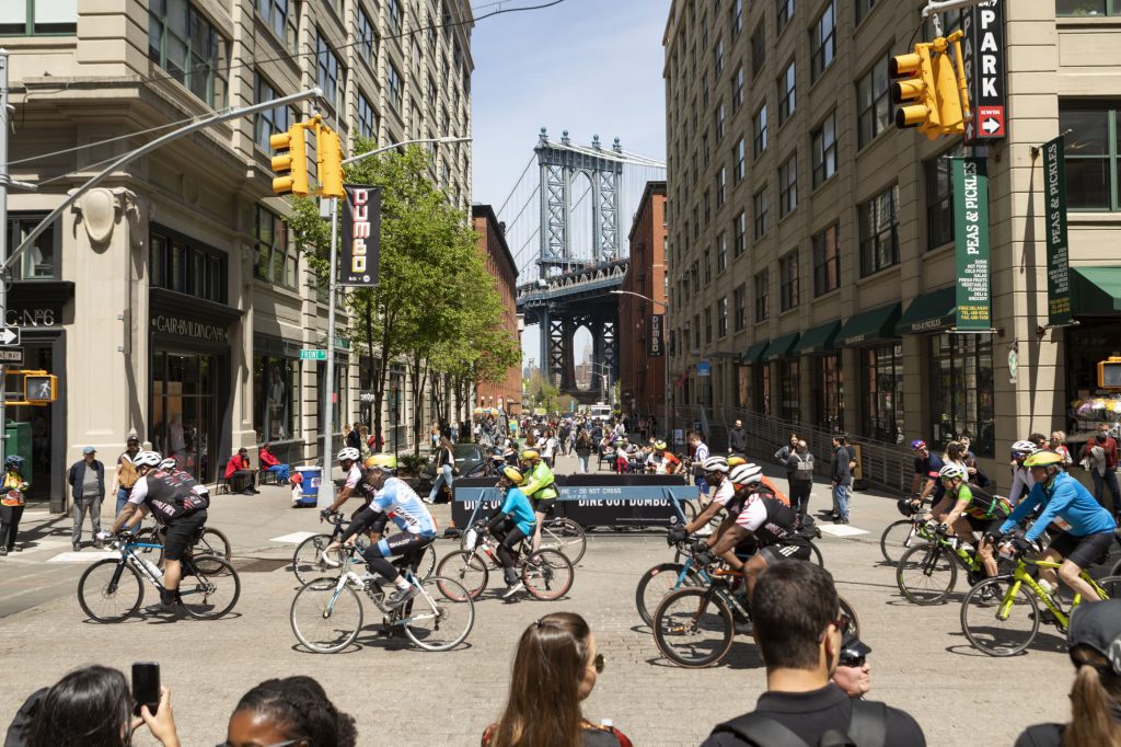 Cyclists riding through a car-free intersection, in the Five Boro Bike Tour