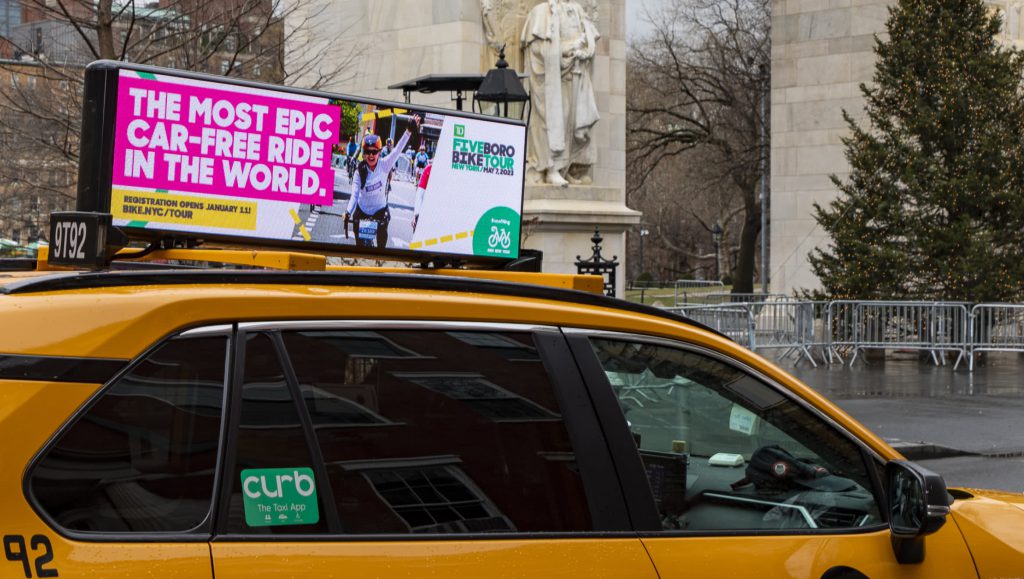 Taxi Ad: The most epic car-free ride in the world.  Registration opens January 11! BIKE.NYC/TOUR TD logo FIVE BORO BIKE TOUR NEW YORK/ MAY 7, 2023