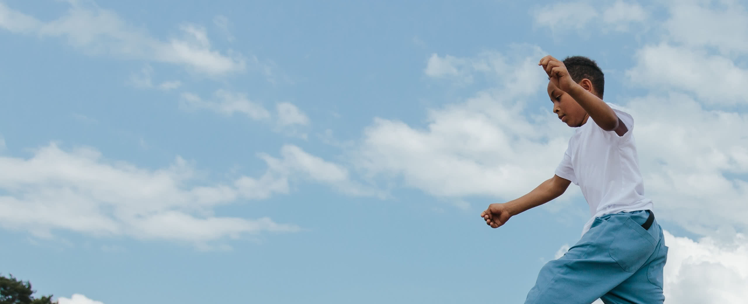 a child playing against a blue sky